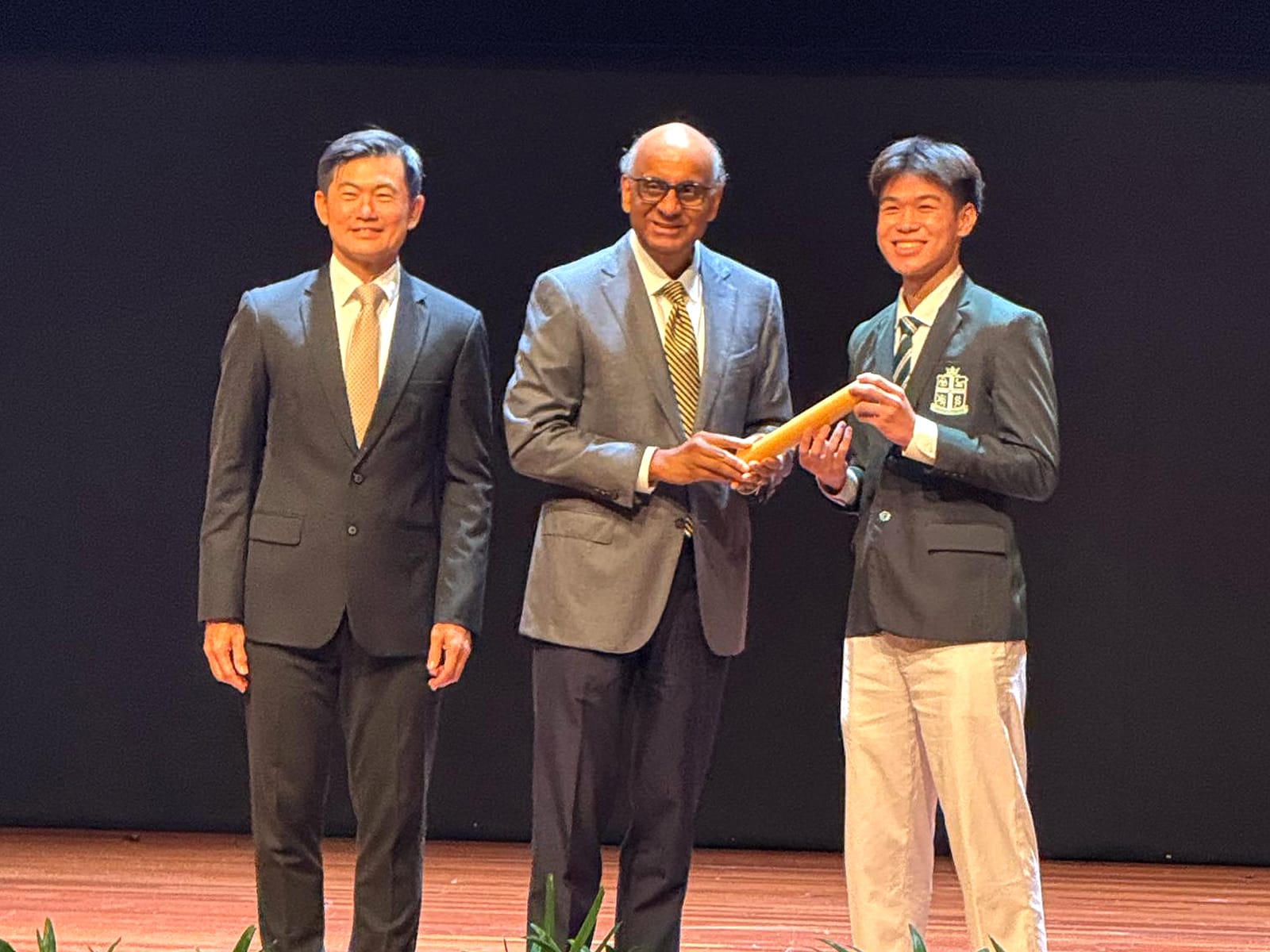 Brian Loh receives the award from President